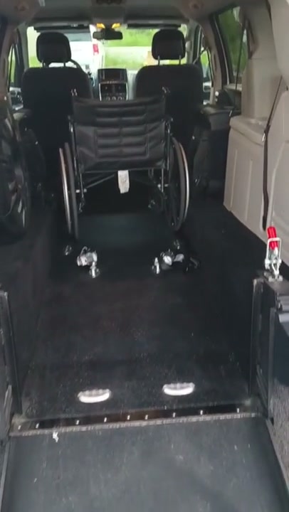 Wheelchair positioned inside accessible Unit 44 with securement hardware visible